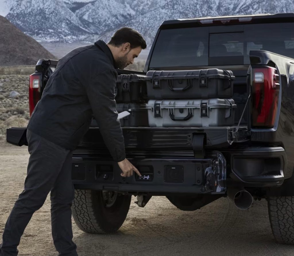 Man adjusting GMC Truck tail hitch