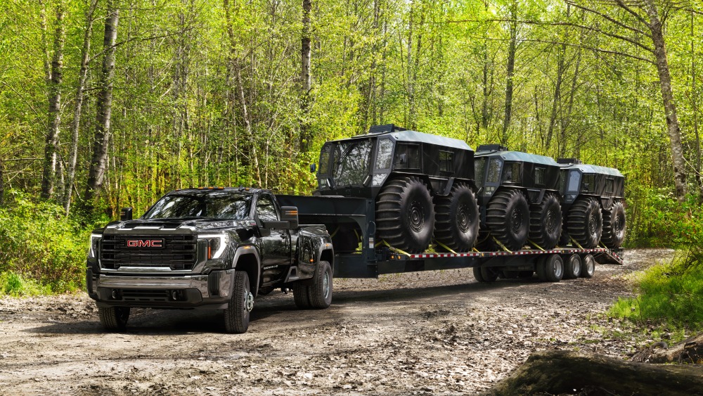 GMC Sierra 3500 Towing/Hauling Two Sherps on Trailer; 3/4 Drivers side Front; Forest background