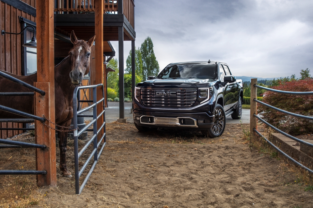 2026 GMC Sierra pulling up to a horse farm